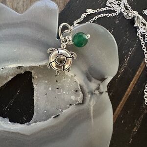 Silver Turtle Pendant Necklace with Green Accent untreated emerald